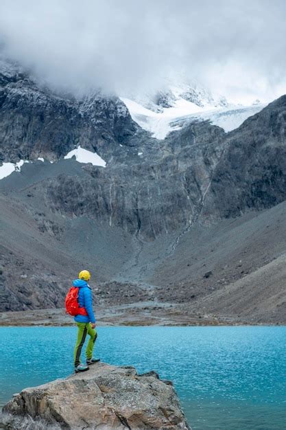 Premium Photo Woman Enjoys Blaisvatnet Blue Lake With Mountains Of