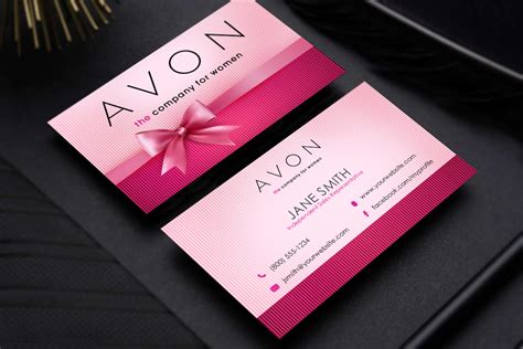 a pink business card with a bow on the front and back, sitting on a ...