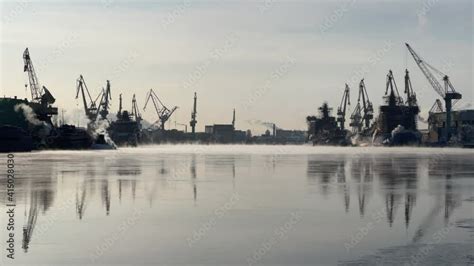 Cranes Of Of The Baltic Shipyard On A Frosty Winter Day Steam Over The