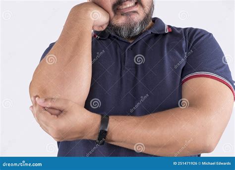 A Man Grimacing From Excruciating Elbow Pain Possible Tendinitis