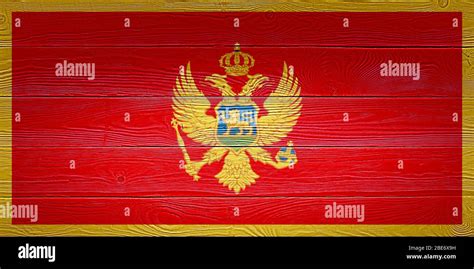 Montenegro flag painted on old wood plank background. Brushed natural ...