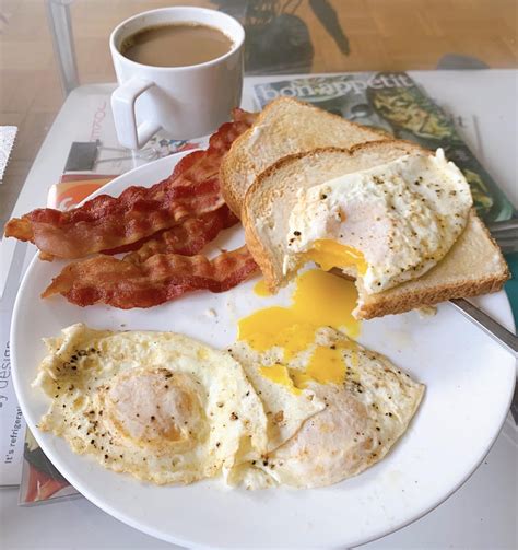 Starting The Day With A Proper Breakfast Three Eggs Over Easy Bacon And Toast Foodporn