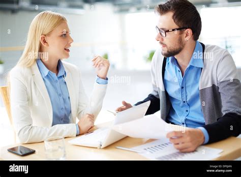 Two Business People Discussing Plans Or Project At Meeting Stock Photo