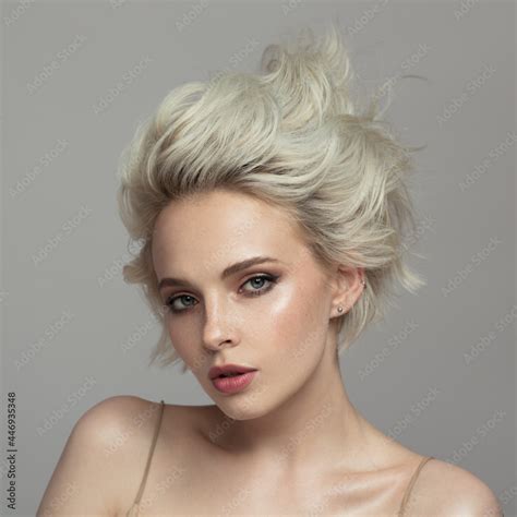 Portrait Of A Beautiful Blonde Girl With A Short Haircut Gray Background Stock Photo Adobe Stock