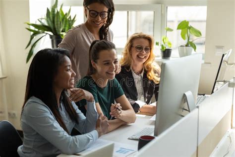 Multiracial Female Colleagues Brainstorm Cooperate At Meeting Stock