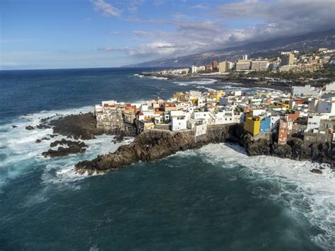 Aerial View On Colorful Houses And Black Lava Rocks In Small Village