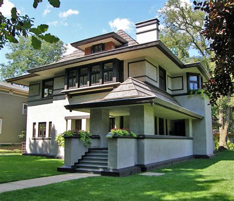 A Large White House Sitting On Top Of A Lush Green Field