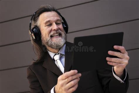 Mature Man Laughing Using Tablet Headphones Stock Photos Free