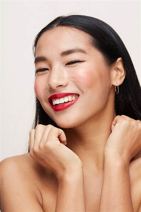 Cute Asian Woman Smiling With Eyes Closed By Stocksy Contributor