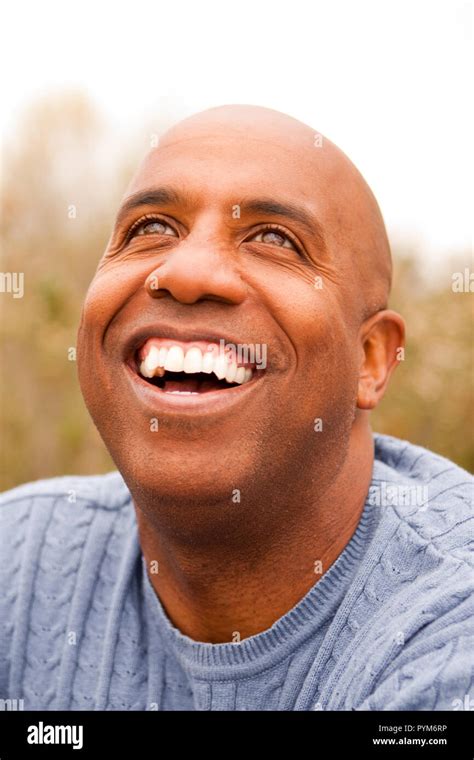 Mature African American Man Smiling Sitting Outside Stock Photo Alamy