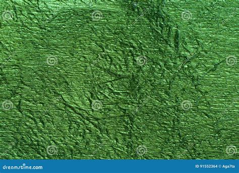 Green Foil Metallic Wall With Glowing Shiny Light Abstract Texture