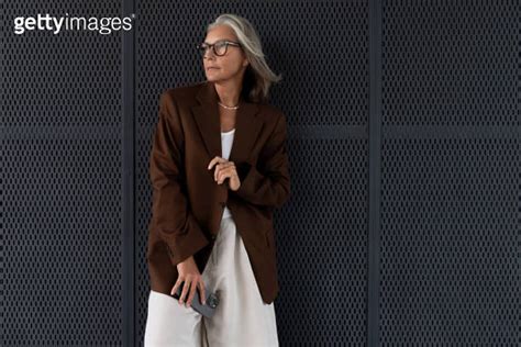 A Slender Gray Haired Mature Business Lady Dressed In A Stylish Jacket