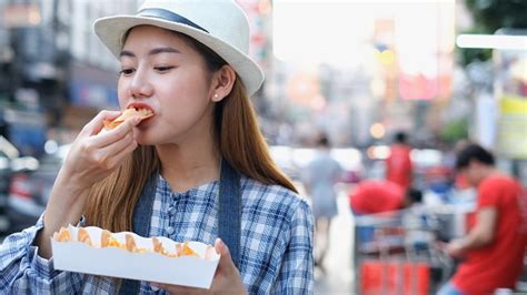 Asian Young Woman Eating Traditional Asian Street Food At Market Bangkok Cityclose Up Of Pretty