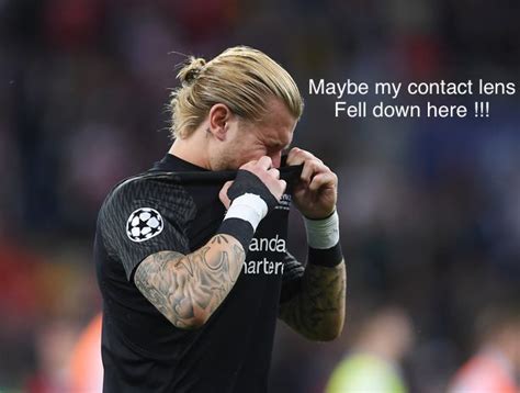 A Male Soccer Player In A Black Shirt Wiping His Face