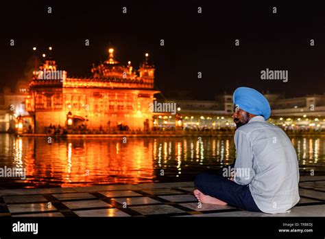 A Sikh Pilgrim Watching The Golden Temple Amritsar Punjab India