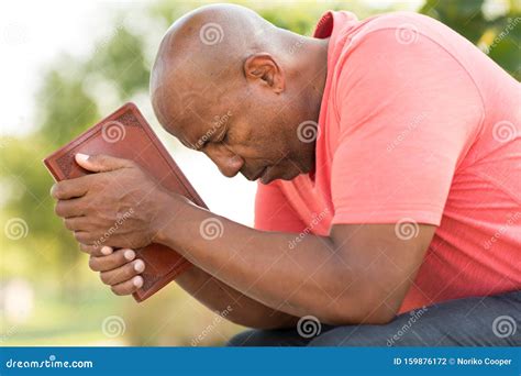 African American Man Praying And Reading The Bible Stock Photo Image