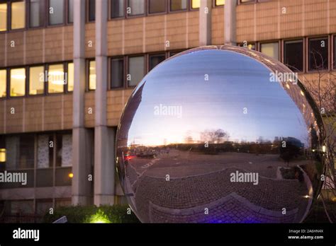 A Large Reflective Silver Ball Imitating A Bearing In Front Of The Skf