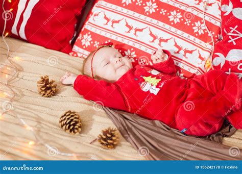 Cute Newborn Baby In A Christmas Costume On A Bed At Home Stock Photo