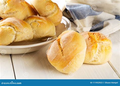 Bunch Of Whole Fresh Baked Wheat Buns On Plate With Kitchen Tow Stock