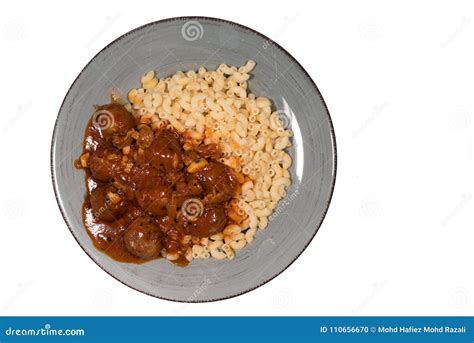 Macaroni With Meatballs And Ketchup In A Plate Isoated On White