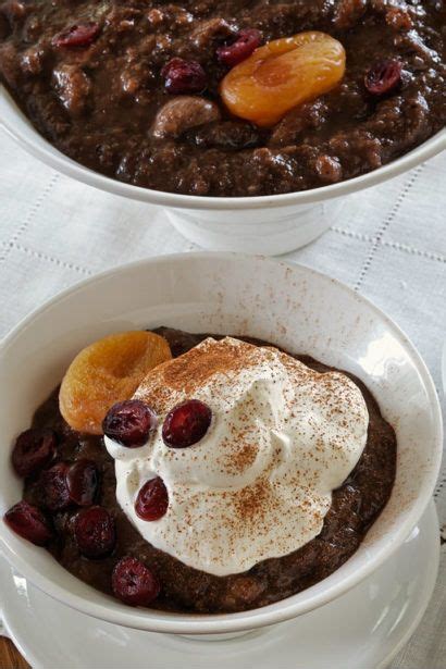 Two White Bowls Filled With Food On Top Of A Table