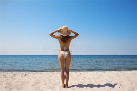 Woman With Perfect Body In Bikini On Sandy Beach Near Sea Back View
