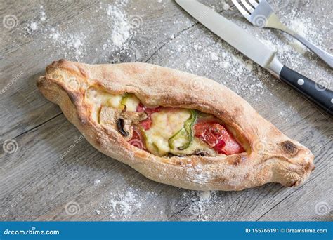 Peinirli Greek Open Faced Pizza Just Baked On Wooden Kitchen Surface