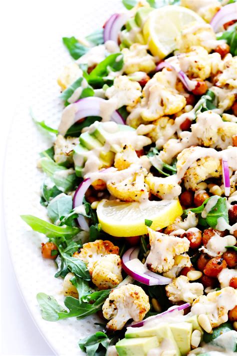 This Roasted Cauliflower Chickpea And Arugula Salad Is Tossed With A Dreamy Tahini Dressing