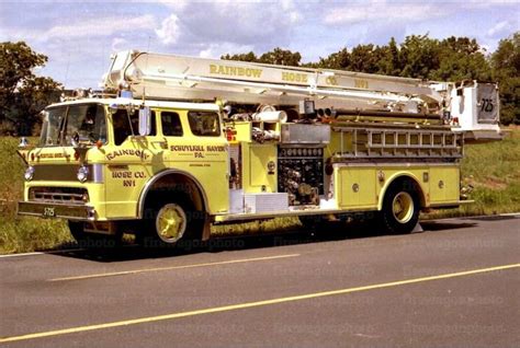 A Yellow Fire Truck Is Parked On The Side Of The Road