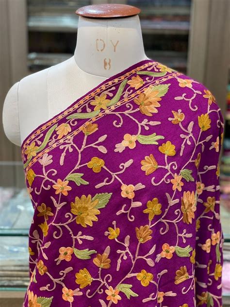 A Mannequin Wearing A Purple And Yellow Floral Print Sari