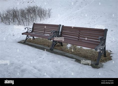 Two Empty Wooden Park Benches On A Snowy Day Stock Photo Alamy