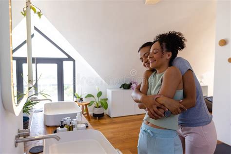 Happy Biracial Lesbian Couple Hugging In Bathroom Stock Photo Image