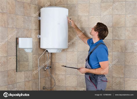 Plumber Checking Electric Boiler Stock Photo AndreyPopov 137860460