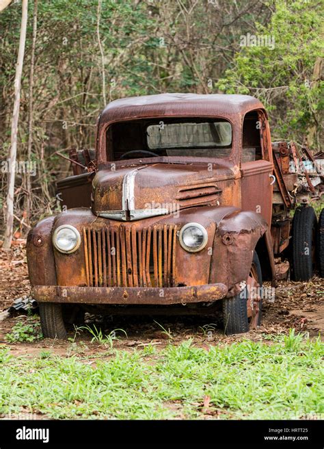 Old abandoned rusty Ford truck in field Stock Photo - Alamy