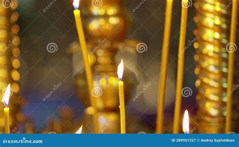 A Golden Candlestick With Burning Candles In The Church On The Altar