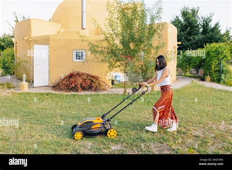 Mature Woman Mowing Backyard Lawn Stock Photo Alamy