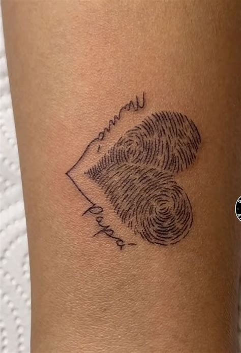 A Woman S Arm With A Fingerprint Tattoo On It