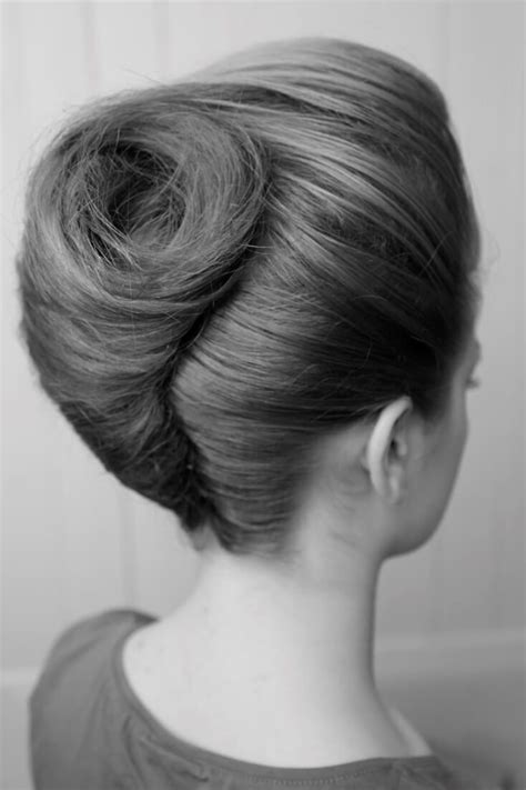 Updo With Hair Twisted Into A Large Victory Roll At The Back And A