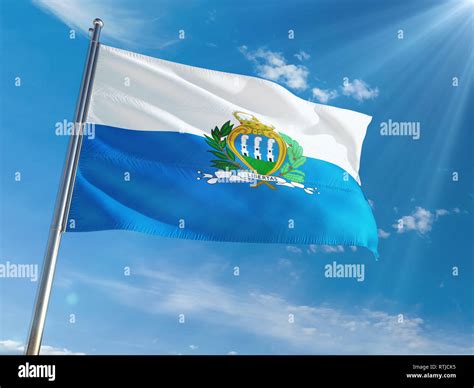 San Marino National Flag Waving On Pole Against Sunny Blue Sky Background High Definition Stock