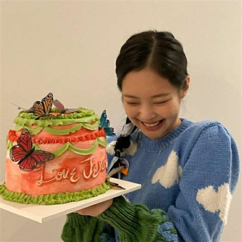 A Woman Holding A Cake With Butterflies On It