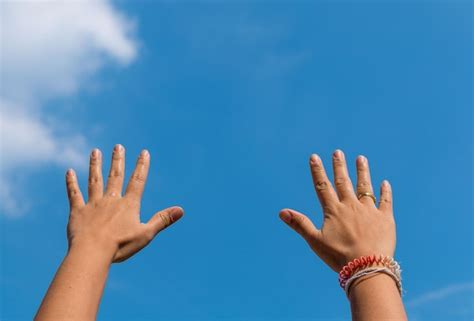 Premium Photo Cropped Hands Of People Against Blue Sky