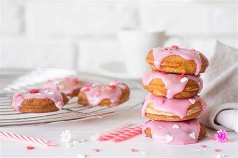 Premium Photo | Stack of pink donuts with heart shaped sprinkles