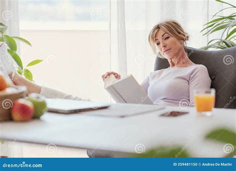 Mature Woman Sitting And Holding A Book Stock Photo Image Of