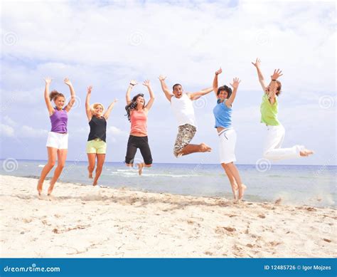 Happy People Jumping On The Beach Stock Photo Image Of Nature Life