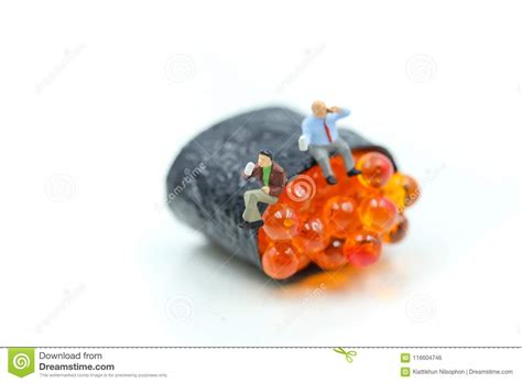 Miniature People Businessman Sitting With Salmon Egg On Sushi Stock