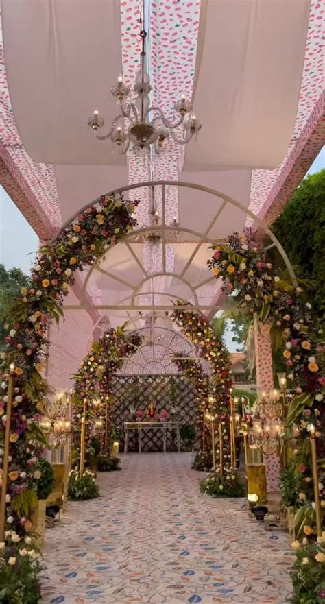 An Archway Decorated With Flowers And Greenery For A Wedding Or