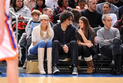 two women sitting next to each other on a bench in front of an audience ...