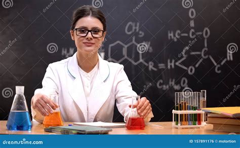 Chemistry Scientist Conducting Researches In Office Holding Flasks