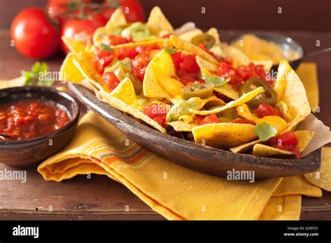 nachos loaded with salsa, guacamole, cheese and jalapeno Stock Photo - Alamy