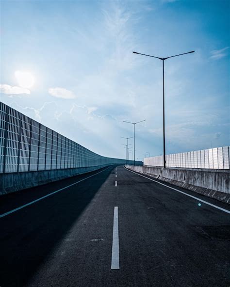 Premium Photo Empty Road With Bridge Against Sky